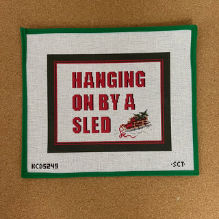 Hanging on by and sled