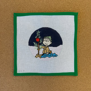 Peanuts "Charlie Brown Christmas"-Linus Kneeling wrapping blanket around tiny tree round